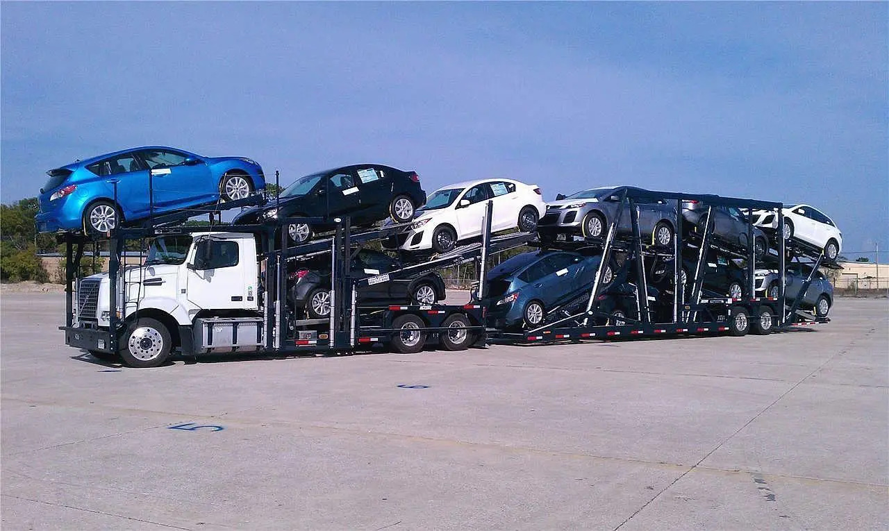 A new car being loaded onto a transport truck, for secure auto shipping services.